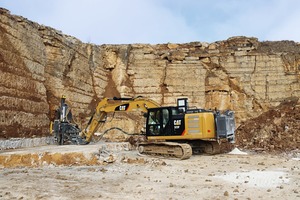  2 A Cat 323FL tracked excavator remotely drills vertical holes into the rock strata 