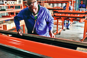  3	A worker inspects a freshly molded belt cleaner blade at the Martin Engineering facility in South Africa 