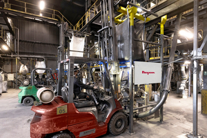  2	A fork truck loads the lifting cradle with bulk bag into receiving cups atop the discharger posts 