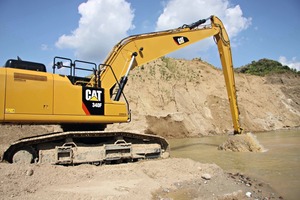  1 The excavator stick dips into the murky water to reach the reserves of sand and gravel 