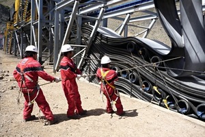  4 Spezialisten positionieren und fixieren die Gurtschlaufen in der Kupfererzmine „Los Pelambres“ # Experts while positioning and fixing the belt loops in the Los Pelambres copper ore mine 